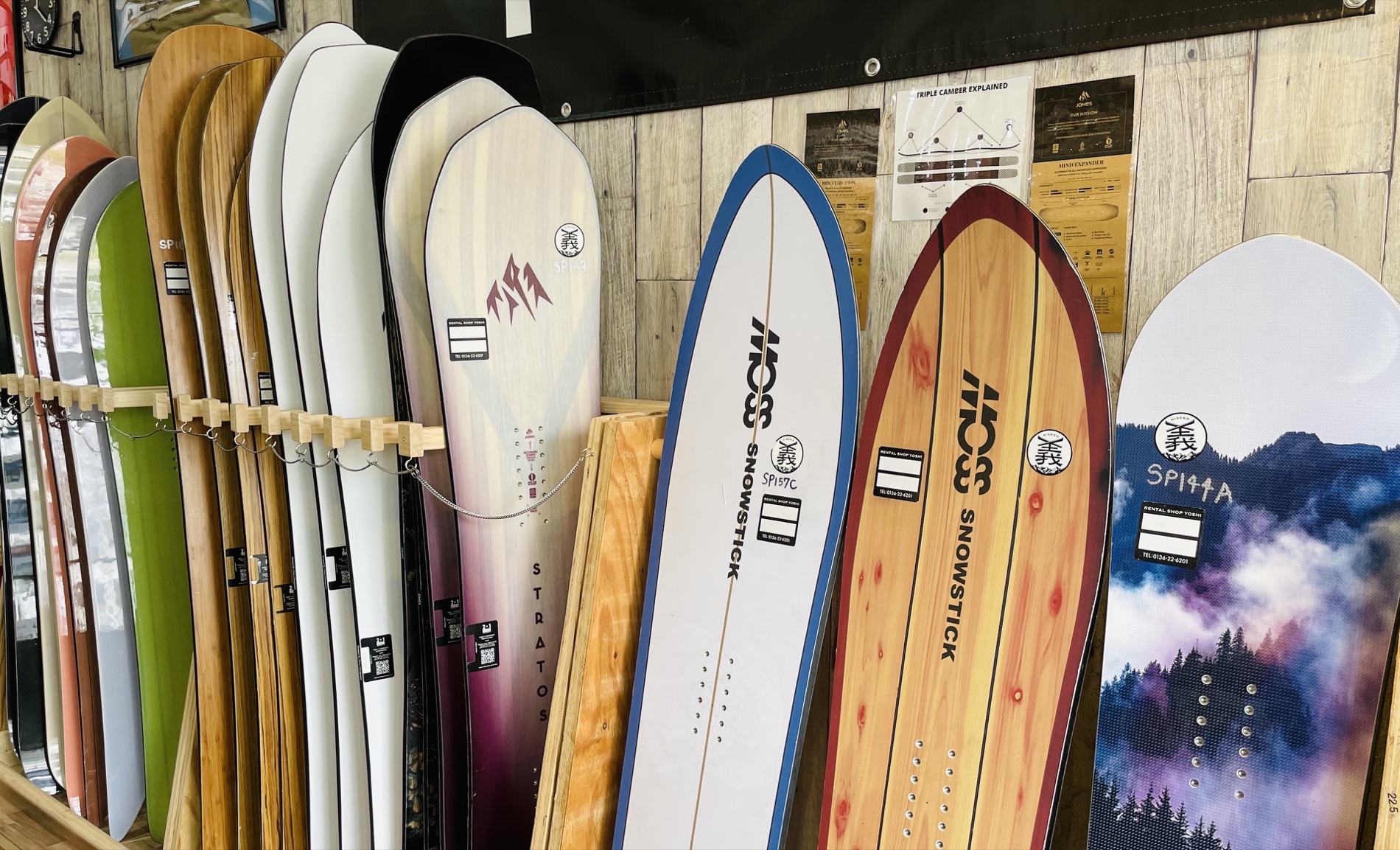 Powder snowboards lined up inside Rental Shop Yoshi